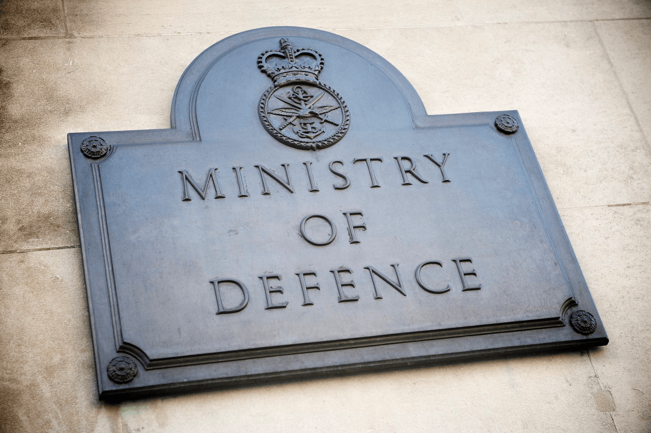Carved stone sign reading 'Ministry of Defence' on a government building facade